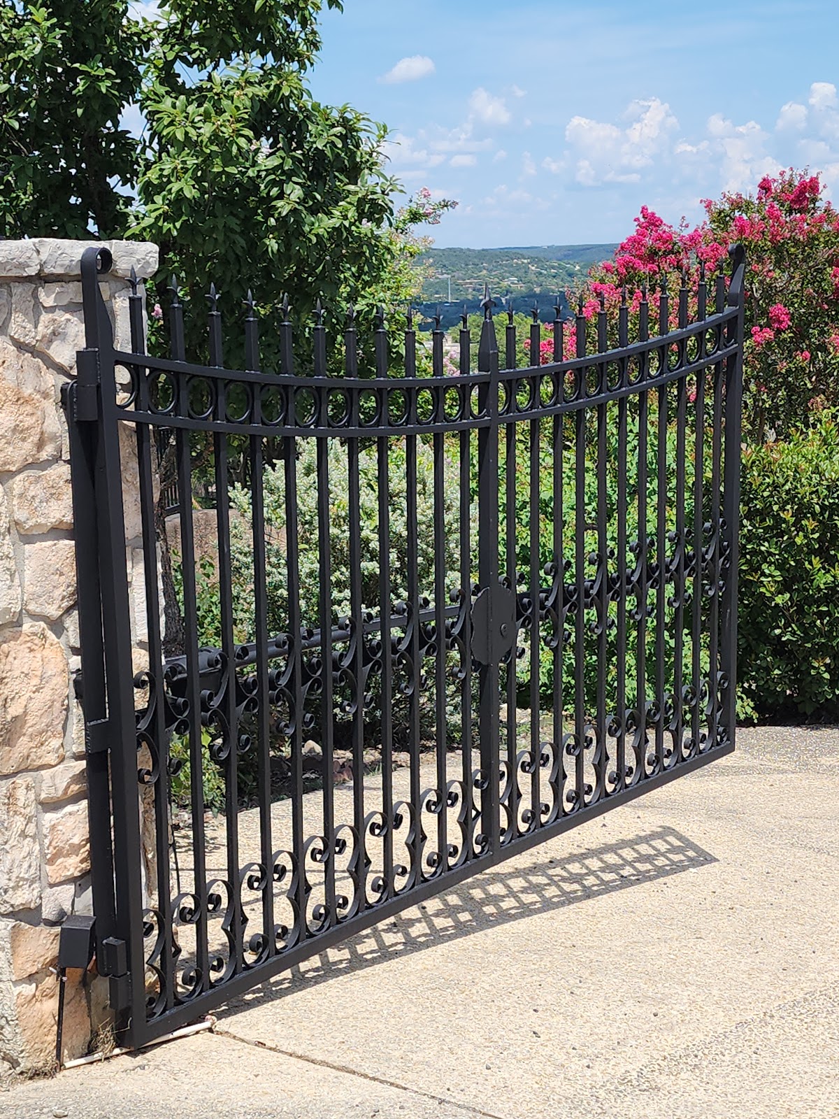 Decorative wrought iron double gate at a Hill Country stone property